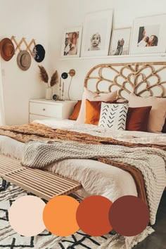 a bedroom with white walls and orange accents on the bed, along with pictures above it