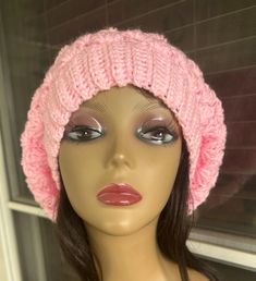 a mannequin head wearing a pink knitted hat