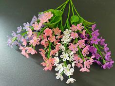 the flowers are all different colors and have green leaves on them for decoration or to decorate