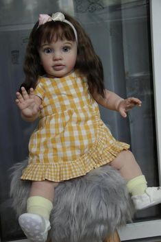 a doll sitting on top of a wooden stool