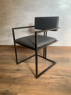 a black chair sitting on top of a hard wood floor