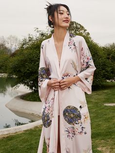 Wrap yourself in the luxurious feel of our ultra-soft, high-quality fabric, adorned with hand-painted floral prints. Designed to care for your skin morning and night, our robe kisses away wrinkles, ensuring joy for every occasion. Experience unmatched comfort and elegance, making each moment a celebration of beauty. • Silky Comfort: Made of high-quality polyester charmeuse, our robes are soft, lightweight and cooling for summer. They have a smooth and breathable texture that feels just like natu Elegant Pink Kimono For Loungewear, Pink Elegant Kimono For Loungewear, Fitted Pink Summer Kimono, Feminine Long Sleeve Kimono For Spring, Feminine Long Sleeve Spring Kimono, Long Sleeve Pink Printed Kimono, Pink Silk Kimono For Spring, Fitted Kimono For Spring Loungewear, Summer Silk Pink Kimono