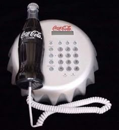 a coca - cola bottle is hooked up to a telephone