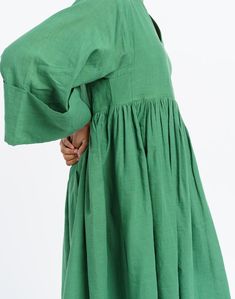 Oversized midi dress in mood elevating basil green color is tailored from handwoven cotton fabric by women artisans of India's western region. Designed for year-round utility, finished with subtle gathers at the waist to give the boxy fit additional contour. This dress would be ideal for transition weather and semi-formal settings. Green Knee-length Midi Dress With Gathered Sleeves, Green Oversized Cotton Maxi Dress, Oversized Green Cotton Maxi Dress, Oversized Green Midi Dress, Billowy Green Dress, Green Cotton Midi Dress For Daywear, Green Cotton Dress With Gathered Sleeves, Green Smock Midi Dress, Green Relaxed Fit Midi Dress For Daywear