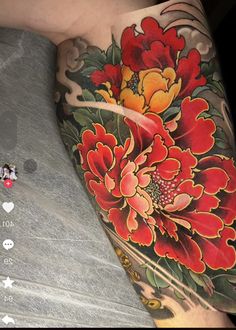 a person with a flower tattoo on their arm and leg next to a cell phone