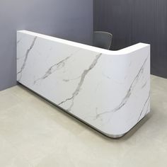 a white marble reception desk in an office