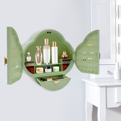 a green wall mounted shelf filled with cosmetics and personal care items