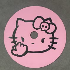 a hello kitty sticker on the side of a pink disc