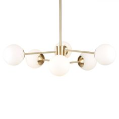 a brass chandelier with five white glass balls