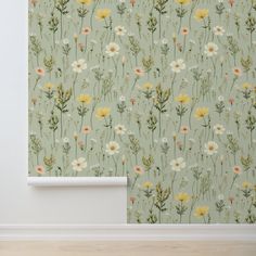 a room with a flower wallpaper and wooden floor