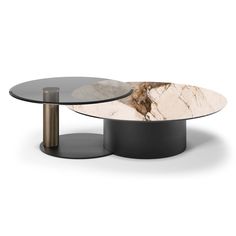 two tables with black bases and white marble on the top, one has a round glass table