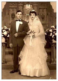 an old black and white photo of a bride and groom standing in front of the alter