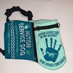 two purses one green and the other blue with an image of a hand print on it