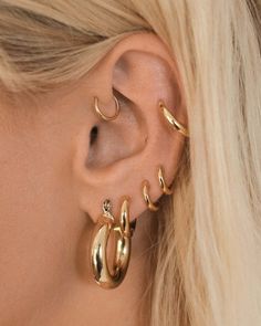 Our best-selling pair of medium-sized hollow + lightweight metal tube hoops that are perfect for everyday wear Sold a pair for pierced ears Outside Diameter: 0.9" (23.5 mm) Tubing is 4.3 mm wide Each hoop weighs 4 grams (considered lightweight) Made from plated brass Plating is 0.3 microns + e-coating for long lasting durability Plated high polish 14K Antique Gold for maximum shine Posts are made from surgical steel so they are very hypo-allergenic for sensitive ears Earrings are 100% nickel-fre Sensitive Ears Earrings, Everyday Earrings Studs, Luv Aj, Gold Ear Cuff, Sofia Richie, Ear Earrings, Candice Swanepoel, Hoop Earring Sets, Large Hoop Earrings