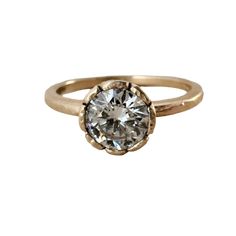 a gold ring with a diamond in the center