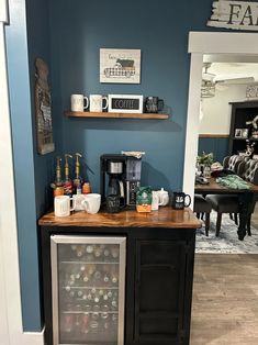 there is a mini fridge in the corner of this room with shelves above it that hold drinks