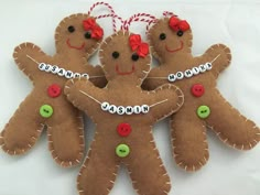 three gingerbread men ornament hanging on a white background with red and green buttons