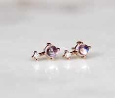 "These earrings are the sweetest! Handcrafted from 14K gold and featuring a moonstone accented by a tiny diamond, our \"Love Drop\" earrings are gorgeous on their own or paired with matching necklace! - 3mm smooth moonstone - Diamond measures 1.3 mm (.01 Ct each) - Available in 14K rose, yellow or white gold - Comes with matching butterfly backings Link to matching necklace here: https://www.etsy.com/listing/511146795/14k-moonstone-diamond-necklace-love-drop?ref=shop_home_active_14 For our ameth Astrology Jewelry, Tiny Diamond, Stone Studs, June Birthstone, Rose Yellow, June Birth Stone, Matching Necklaces, Drop Necklace, Dainty Jewelry