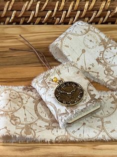 two pieces of fabric sitting on top of a wooden table