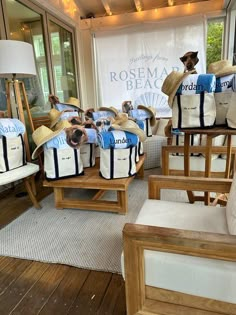 several chairs with hats on them in front of a store window and a sign that says rosema beach