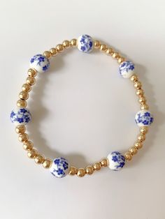 Blue Floral gold beaded bracelet Gold 14k Gold-filled Round Beads Pearl Bracelet, Blue Beaded 14k Gold-filled Jewelry, Elegant Gold Stretch Bracelet With Large Beads, Dainty 14k Gold-filled Bracelets With Colorful Beads, Colorful Metal Beads Jewelry, Colorful Metal Beads Bracelet Jewelry, Adjustable Gold Jewelry With Colorful Beads, Gold Pearl Bracelet With 14k Gold Beads, 14k Gold Filled Pearl Bracelet