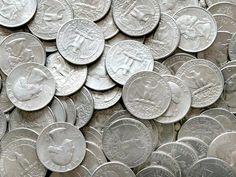 a pile of silver coins sitting on top of each other