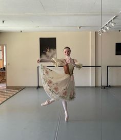 a woman in a white dress is dancing