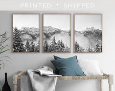 three black and white pictures hanging on the wall above a bed with pillows, vases and