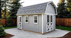 a small gray shed sitting in the middle of a yard