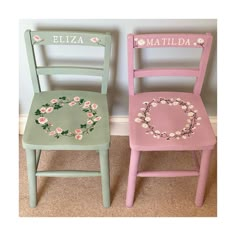 two children's wooden chairs with flowers painted on the back and sides, one has a wreath