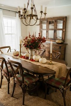 Farmhouse dining room with burlap table runner, white pumpkins, and brass candle holders Fall Diningroom Table Decor, Large Dining Table Fall Decor, Breakfast Table Fall Decor, Fall Table Decor Dining Room, Autumn Dining Table, Oval Dining Table Fall Decor, Vintage Dining Table Decor, Dining Table Fall Celing, Cottage Dining Room Ideas