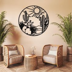 a living room with two chairs and a cactus wall decal on the wall above them