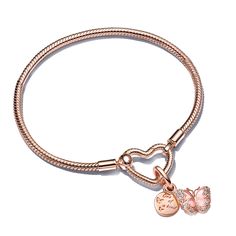 Embody the beauty of change, personal growth and positive transformation with a bracelet set that's truly one of a kind. The Pandora Moments Heart Closure Snake Chain Bracelet, hand-finished with 14k rose gold plating, gracefully showcases the Pink Butterfly & Quote Double Dangle Charm. This spring-inspired charm dazzles with two distinct 14k rose gold-plated charms: the first, a round disk with tiny butterflies on one side and the engraved words, "One of a Kind" on the other; the second, a read Pandora Heart Bracelet, Pandora Butterfly, Butterfly Quote, Pandora Pink, Pandora Heart, Wedding Day Jewelry, Rose Heart, Snake Chain Bracelets, Butterfly Bracelet