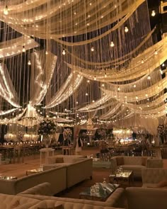 a large room filled with lots of lights and chandeliers hanging from the ceiling