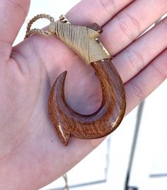 Pendant:  Approx. 44mm x 67mm Cord Necklace:  Approx. 28" long (Adjustable) This is a beautifully hand-crafted pendant made of natural koa wood  in a traditional tribal fish hook design.  Brown braided cotton necklace has an adjustable sliding knot to adjust the necklace into any desirable length.  Wear it close to your neck as a choker or longer as a pendant/necklace. Maori Pendant, Unique Brown Carved Necklace, Maori Fish Hook Necklace, Adjustable Artisan Natural Wood Necklace, Adjustable Natural Wood Necklace Nature-inspired, Cotton Necklace, Wood Fish, Koa Wood, Hawaiian Jewelry