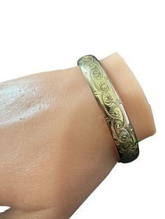 Beautifully etched floral 1890s hinged bangle bracelet. The bracelet is 12k gold filled with an ornate etched pattern around the circumference of the bracelet. The bracelet is fitted with a hidden clasp and safety clasp. ERA - Circa 1890s METAL / MATERIAL - 12k gold filled  MARKINGS / HISTORY - N/A CONDITION - Good vintage condition. Gold filled metal has been polished & cleaned. Age appropriate patina & wear remains. Amazing vintage bangle bracelet! MEASUREMENTS - Inner circumference: 7 inches, Luxury Engraved Victorian Cuff Bracelet, Luxury Antique Engraved Cuff Bracelet, Bracelet Measurements, Vintage Bangle Bracelets, Vintage Bangles, Hinged Bangle, Metal Material, Victorian Era, Statement Jewelry