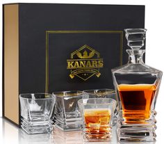 an assortment of whiskey glasses sitting in front of a box