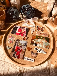 a table topped with lots of pictures and magnets on top of a wooden board