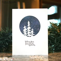 a christmas card with pine trees and the words wishing you a merry season written on it