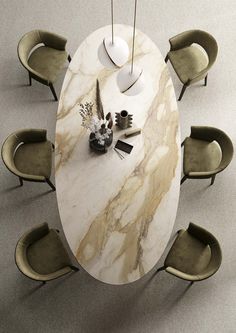 a marble dining table with chairs around it