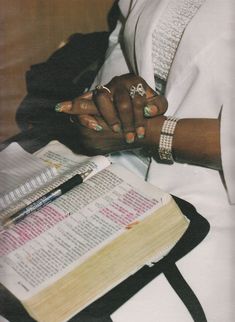 a woman sitting in front of an open bible