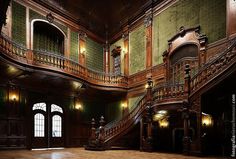 an old building with wooden stairs and green walls