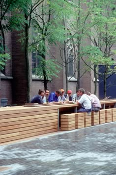 people are sitting on benches in the park