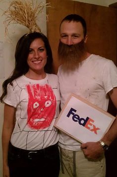 a man with a long beard standing next to a woman holding a fedex box