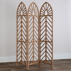 two decorative wooden screens sitting on top of a hard wood floor