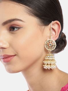 These gorgeous flower & dome shaped jhumki earrings come with kundan stone studs and off-white beaded danglers, are gold-plated, and secured with a post and back closure. Comes with beaded detachable ear chains. These handcrafted jhumkis can be styled with any traditional outfit, or an evening outfit to complete a dazzling look. Product color may vary based on the monitor or screen you are using.See FAQ for more details. Size Length of earring: 5.5 cmLength of ear chain: 10.5 cm Details Material Indian Earrings With Chain, Jhumka With Ear Chain, Ear Chain Designs, Polki Designs, Ear Chain Traditional, Gold Ear Chain, Climbers Earrings, Desi Jewellery, Earrings With Chain