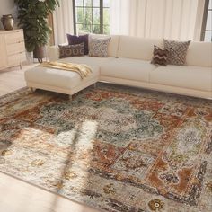 a living room with a large rug on the floor and a white couch in front of it