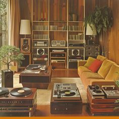 The retro, bohemian vibe of this 1970s living space is enhanced by the presence of a portable, suitcase-style record player, its compact, weathered case covered in retro-inspired stickers and its tinny, lo-fi speaker 70s Interior Design Retro, 70s House Decor, 70s Inspired Living Room, Living Room 70s, 70s Living Room Decor, 1970s Living Room, 70s Room, 70s Living Room, 70s Interior Design