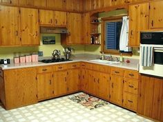 a kitchen with wooden cabinets and tile flooring, including a white stove top oven