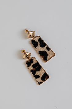 Everyone will admire your impeccable style when you wear the Serena Leopard Drop Earrings! These trendy earrings start with a stud post back and have a drop design with leopard detailing. Add these fun earrings to a black dress + heels to add a chic touch to your date night look! Gold Plated Leopard Print Drop Shape Stud Post Back One Size | Length 2” Leopard Print Drop Earrings Gift, Trendy Leopard Print Dangle Earrings, Leopard Print Earrings For Gift, Leopard Print Earrings For Pierced Ears As Gift, Black Dress Heels, Black Dress With Heels, Sneaker Heels Wedges, Fall Flannel, Cute Leopard